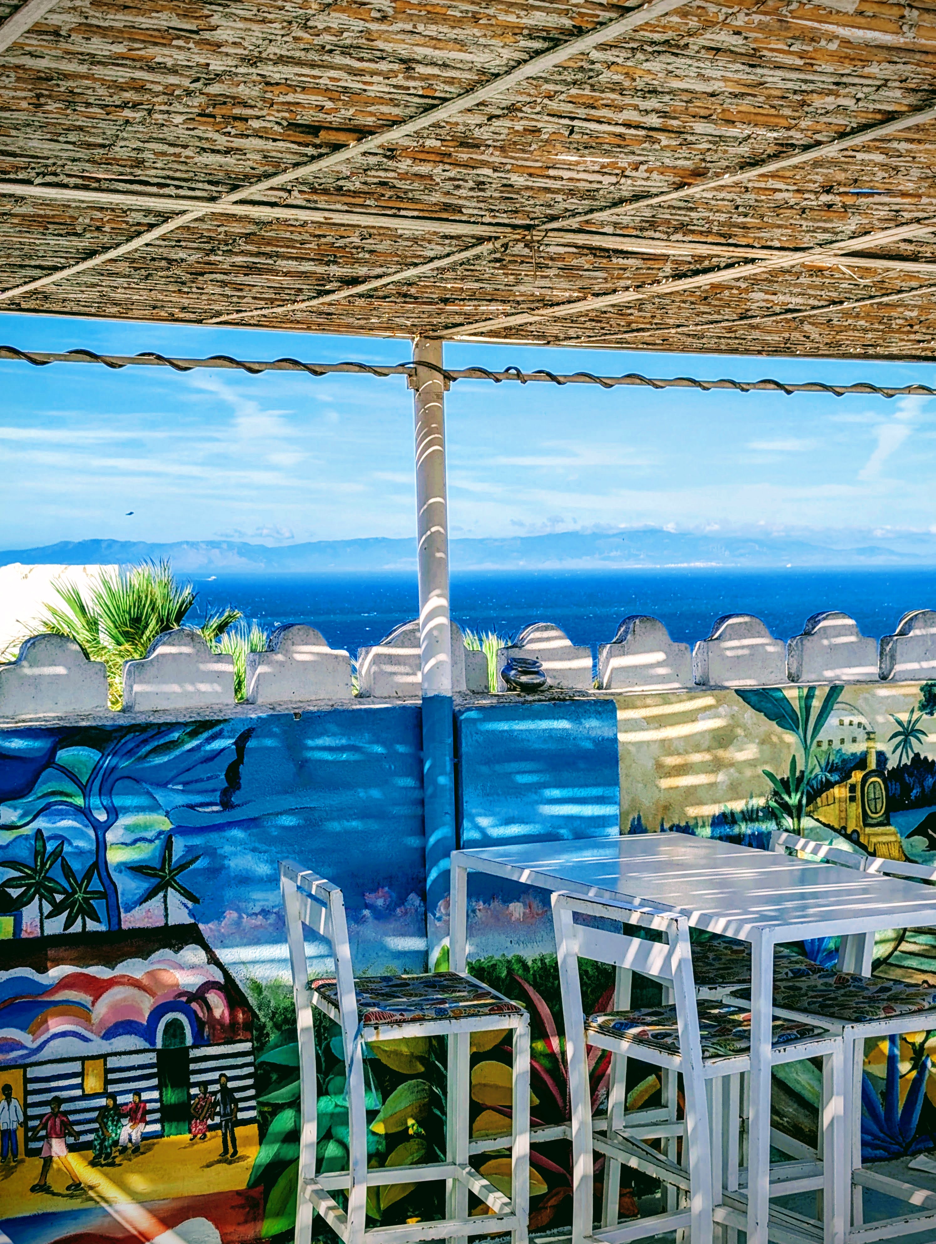 A colorful Moroccan terrace with views over the sea